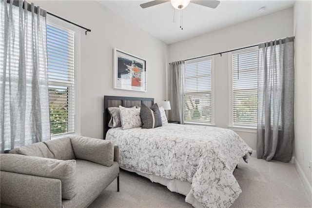 carpeted bedroom featuring baseboards and ceiling fan