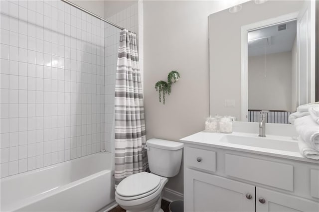 full bath featuring vanity, shower / bath combo with shower curtain, and toilet