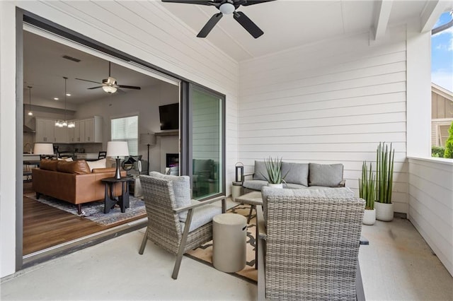 view of patio / terrace with visible vents, a ceiling fan, a sink, and an outdoor living space