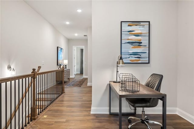 hall featuring recessed lighting, baseboards, an upstairs landing, and wood finished floors