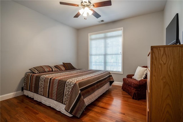 bedroom featuring ceiling fan and dark wood-type flooring