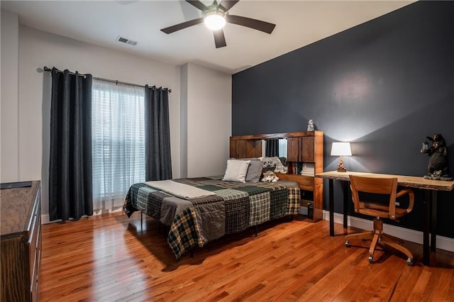 bedroom with ceiling fan and light hardwood / wood-style floors