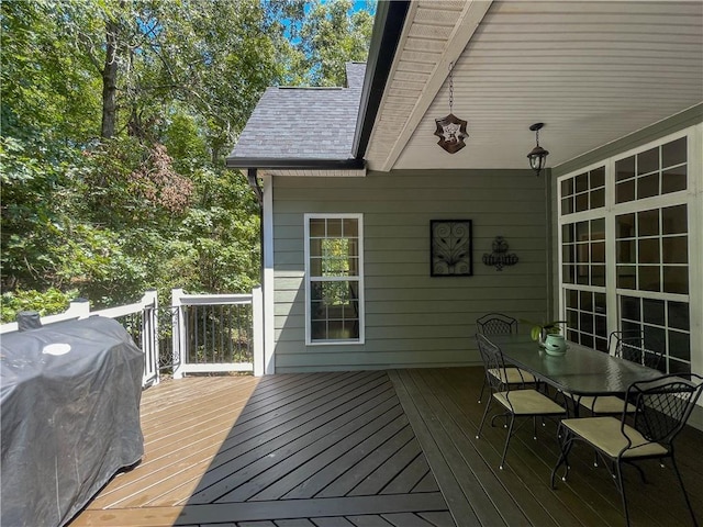 wooden deck featuring a grill