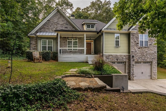 view of front of home with a porch, a garage, and a front yard