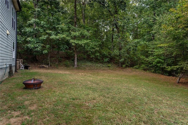 view of yard with an outdoor fire pit