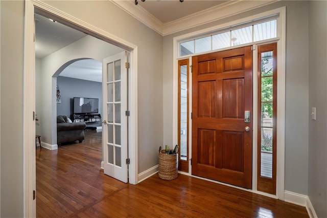 foyer entrance featuring dark hardwood / wood-style flooring and crown molding