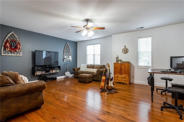 living room with ceiling fan and hardwood / wood-style floors