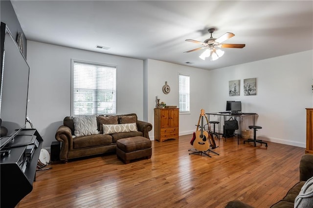 living room with hardwood / wood-style flooring and ceiling fan