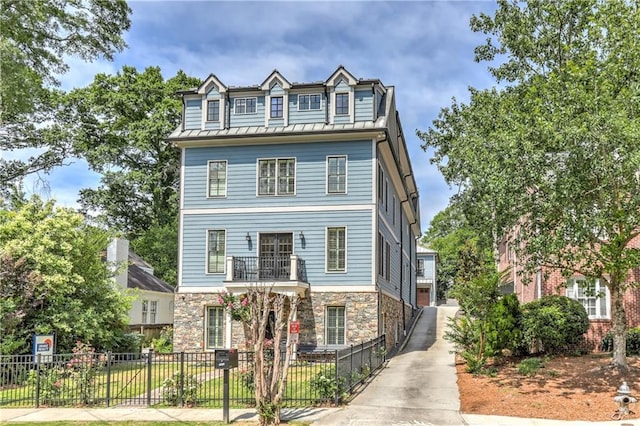 2972 Lookout Pl NE, Atlanta, GA 30305 - view of front of property featuring stone siding, a fenced front yard, a metal roof, and a standing seam roof
