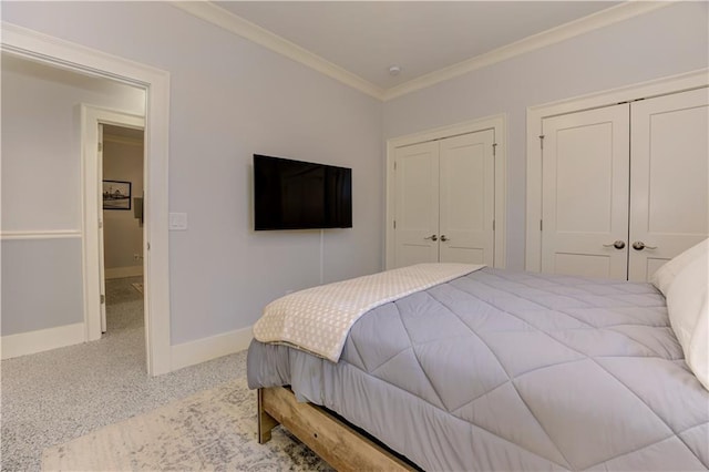 2972 Lookout Pl NE, Atlanta, GA 30305 - bedroom with multiple closets, ornamental molding, and speckled floor