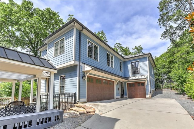 2972 Lookout Pl NE, Atlanta, GA 30305 - view of front of home featuring an attached garage, a standing seam roof, a metal roof, and concrete driveway