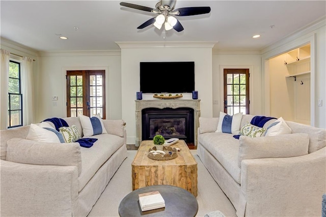 2972 Lookout Pl NE, Atlanta, GA 30305 - living room featuring plenty of natural light, a ceiling fan, crown molding, a glass covered fireplace, and recessed lighting