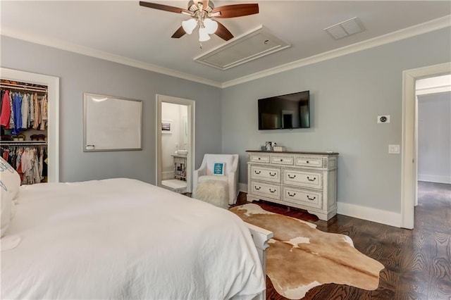 2972 Lookout Pl NE, Atlanta, GA 30305 - bedroom featuring attic access, crown molding, dark wood-type flooring, a walk in closet, and connected bathroom