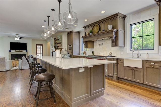 2972 Lookout Pl NE, Atlanta, GA 30305 - kitchen with healthy amount of natural light, a ceiling fan, open floor plan, a fireplace, and recessed lighting