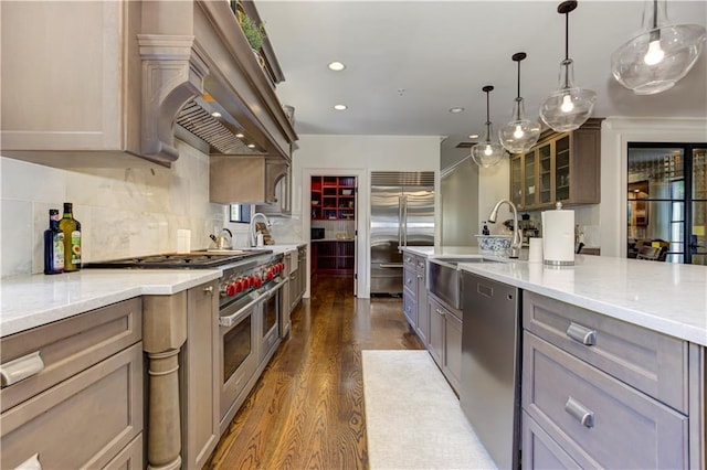2972 Lookout Pl NE, Atlanta, GA 30305 - kitchen with high end appliances, dark wood-type flooring, decorative backsplash, recessed lighting, and glass insert cabinets