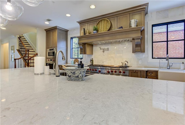 2972 Lookout Pl NE, Atlanta, GA 30305 - kitchen featuring stainless steel appliances, light stone countertops, recessed lighting, backsplash, and plenty of natural light