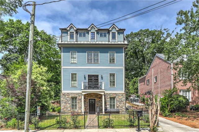 2972 Lookout Pl NE, Atlanta, GA 30305 - view of front of property with a balcony, stone siding, a fenced front yard, and covered porch