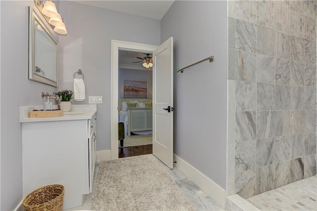 2972 Lookout Pl NE, Atlanta, GA 30305 - bathroom with vanity, a tile shower, connected bathroom, a ceiling fan, and marble finish flooring