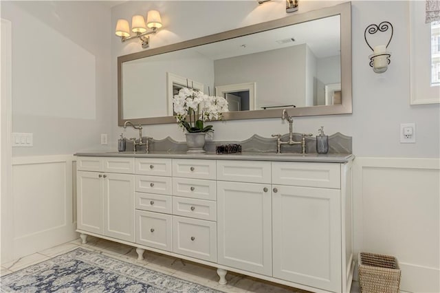 2972 Lookout Pl NE, Atlanta, GA 30305 - full bathroom featuring a decorative wall, double vanity, wainscoting, and marble finish flooring