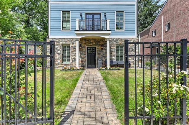 2972 Lookout Pl NE, Atlanta, GA 30305 - view of front facade with a balcony, stone siding, and a fenced backyard