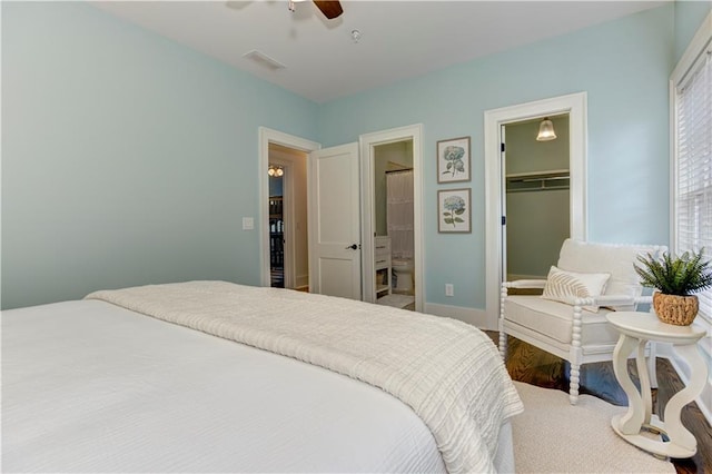 2972 Lookout Pl NE, Atlanta, GA 30305 - bedroom with a spacious closet, ensuite bath, a closet, a ceiling fan, and wood finished floors