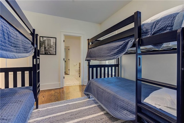 2972 Lookout Pl NE, Atlanta, GA 30305 - bedroom with wood finished floors and connected bathroom