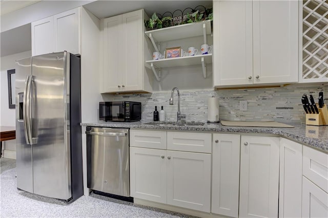 2972 Lookout Pl NE, Atlanta, GA 30305 - kitchen featuring stainless steel appliances, decorative backsplash, white cabinetry, and light stone countertops