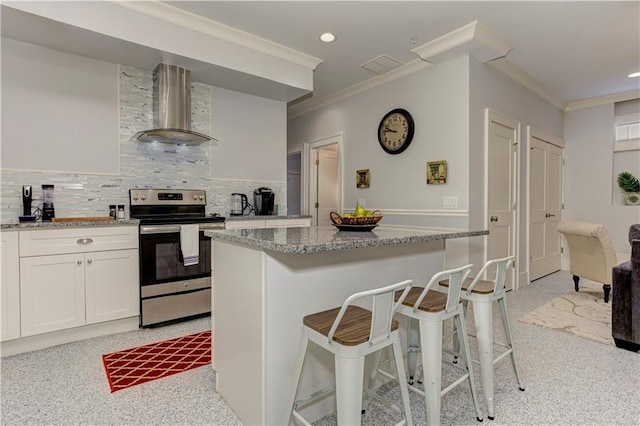 2972 Lookout Pl NE, Atlanta, GA 30305 - kitchen featuring electric stove, wall chimney range hood, crown molding, light stone countertops, and decorative backsplash