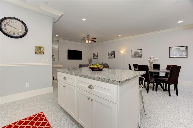 2972 Lookout Pl NE, Atlanta, GA 30305 - kitchen featuring ornamental molding, a kitchen island, a ceiling fan, white cabinets, and recessed lighting