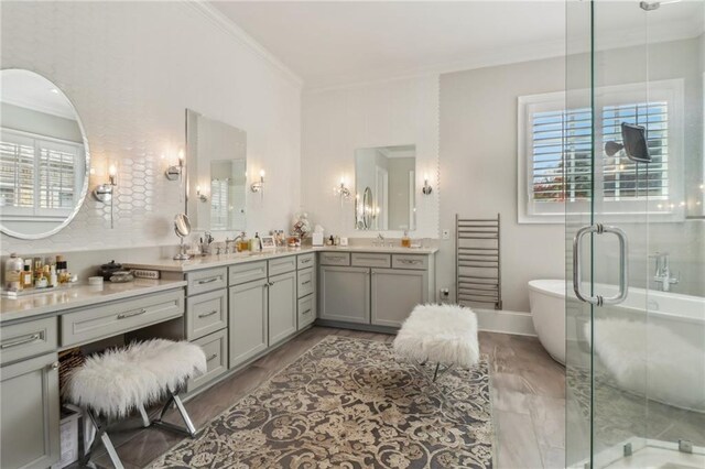 kitchen with visible vents, stainless steel appliances, a sink, crown molding, and wall chimney exhaust hood