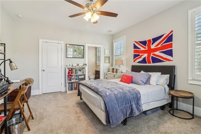 bedroom with visible vents, crown molding, baseboards, light wood-style flooring, and a ceiling fan
