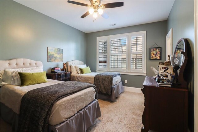 living area with visible vents, baseboards, light colored carpet, and crown molding