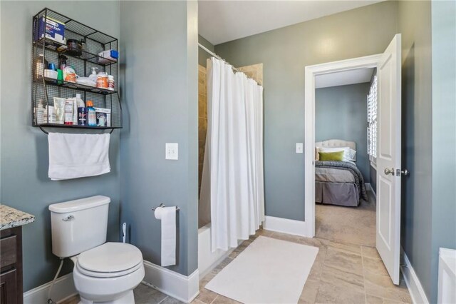 bedroom with visible vents, connected bathroom, baseboards, and carpet floors