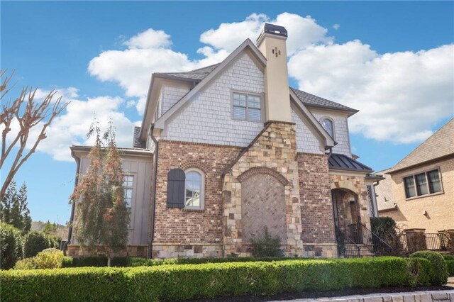 traditional home with brick siding, an attached garage, concrete driveway, and a front yard