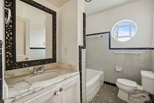 bathroom featuring vanity, a bathing tub, crown molding, toilet, and tile walls