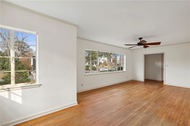 unfurnished room featuring ceiling fan, crown molding, and light hardwood / wood-style flooring