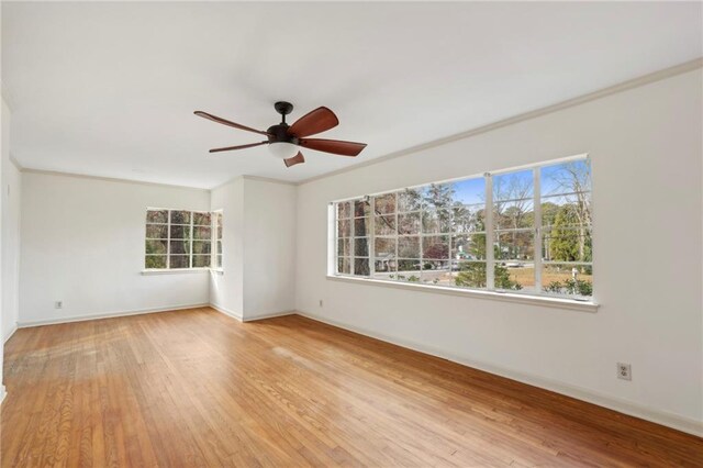 unfurnished room with crown molding, light hardwood / wood-style flooring, and ceiling fan