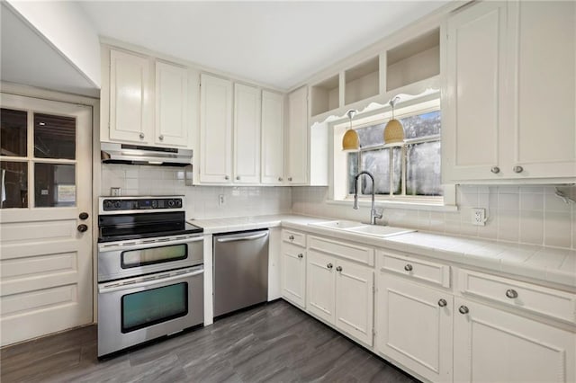 kitchen with white cabinets, stainless steel appliances, dark wood-type flooring, and sink