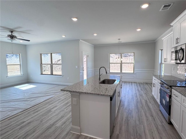 635 Forest Way, Cornelia, GA 30531 - kitchen featuring appliances with stainless steel finishes, a sink, a center island with sink, ceiling fan, and white cabinetry