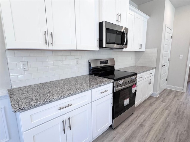 635 Forest Way, Cornelia, GA 30531 - kitchen featuring stainless steel appliances, light wood-style flooring, and light stone counters