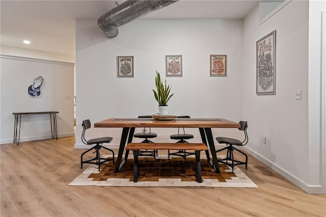 dining space featuring baseboards, light wood-type flooring, and recessed lighting