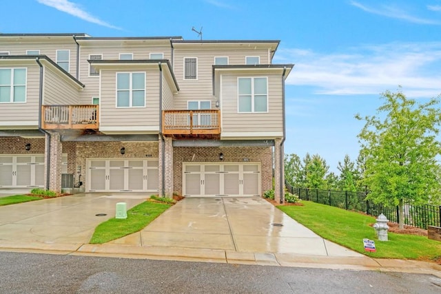 5217 Riden Ct Unit 263, Buford, GA 30518 - view of front of property featuring brick siding, a balcony, driveway, and a garage