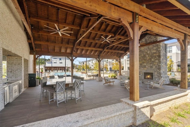 5217 Riden Ct Unit 263, Buford, GA 30518 - wooden terrace with an outdoor stone fireplace and a patio