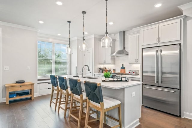 5217 Riden Ct Unit 263, Buford, GA 30518 - kitchen featuring high end refrigerator, wall chimney exhaust hood, a sink, crown molding, and backsplash
