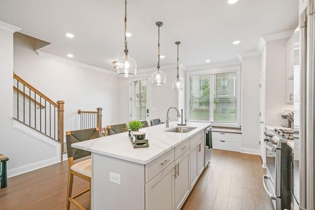 5217 Riden Ct Unit 263, Buford, GA 30518 - kitchen featuring a sink, high quality appliances, ornamental molding, a breakfast bar, and white cabinetry