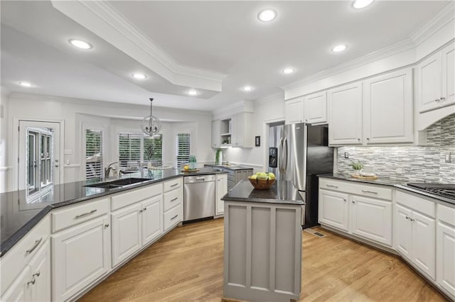kitchen featuring appliances with stainless steel finishes, crown molding, a sink, recessed lighting, and white cabinets