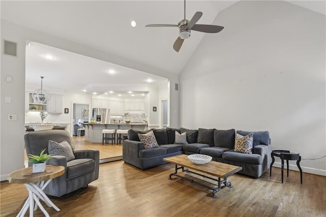 living room featuring recessed lighting, ceiling fan, wood finished floors, high vaulted ceiling, and baseboards