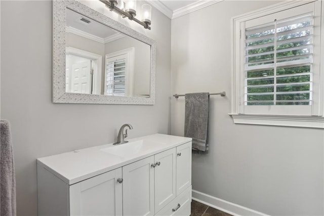 bathroom featuring ornamental molding, baseboards, plenty of natural light, and vanity