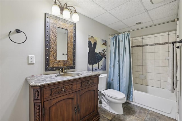 full bathroom with a drop ceiling, toilet, tile patterned floors, shower / bathtub combination with curtain, and vanity