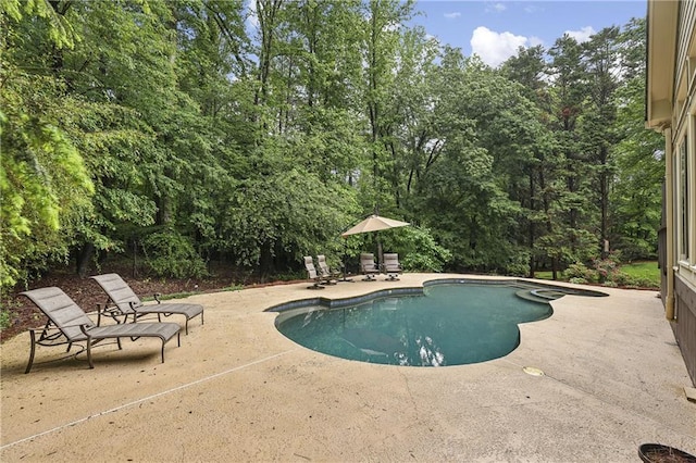 outdoor pool with a patio area